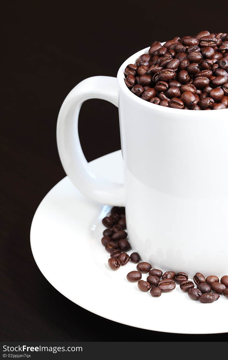 Coffee mug filled with fresh coffee beans