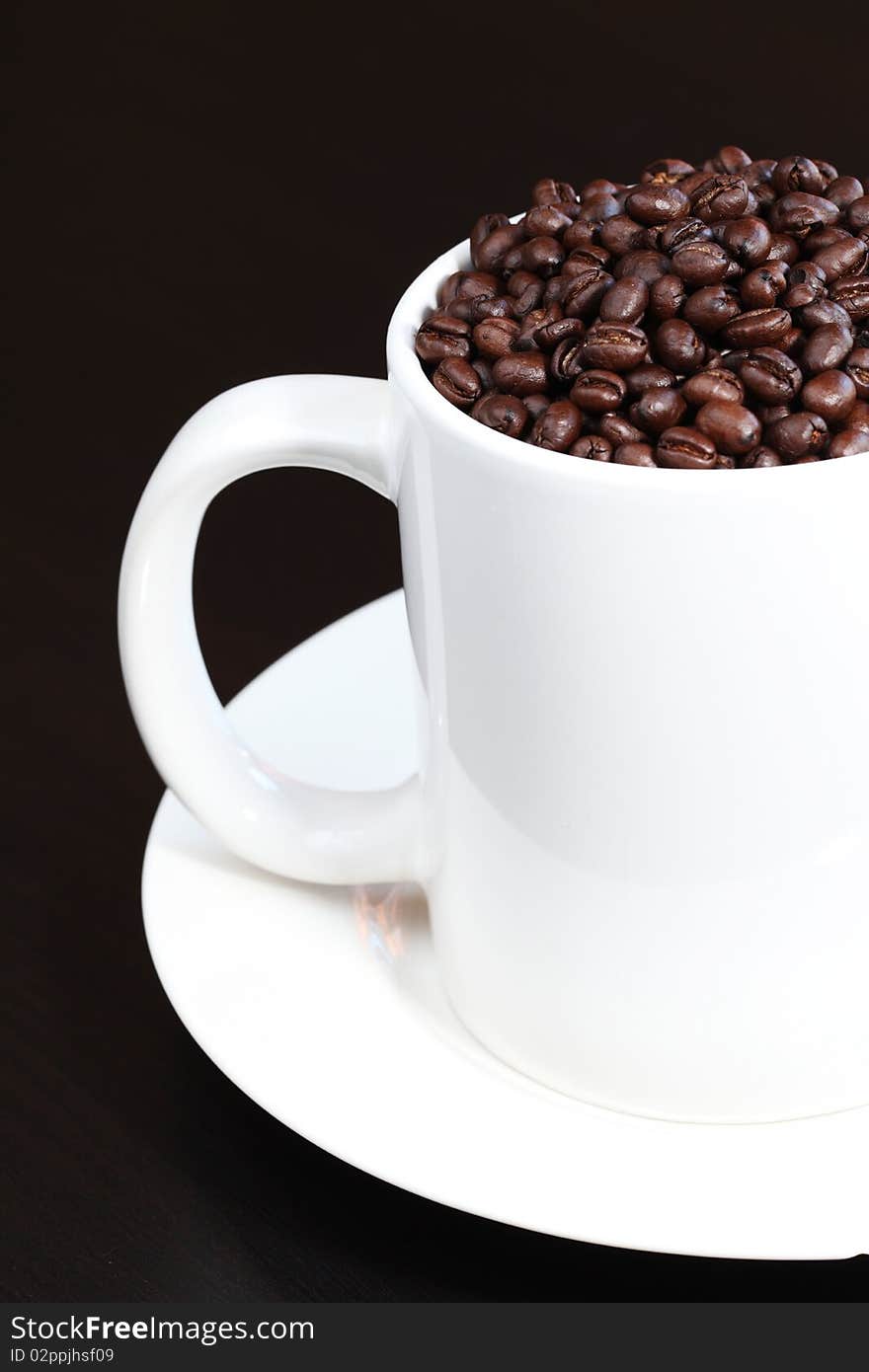 Coffee mug filled with fresh coffee beans