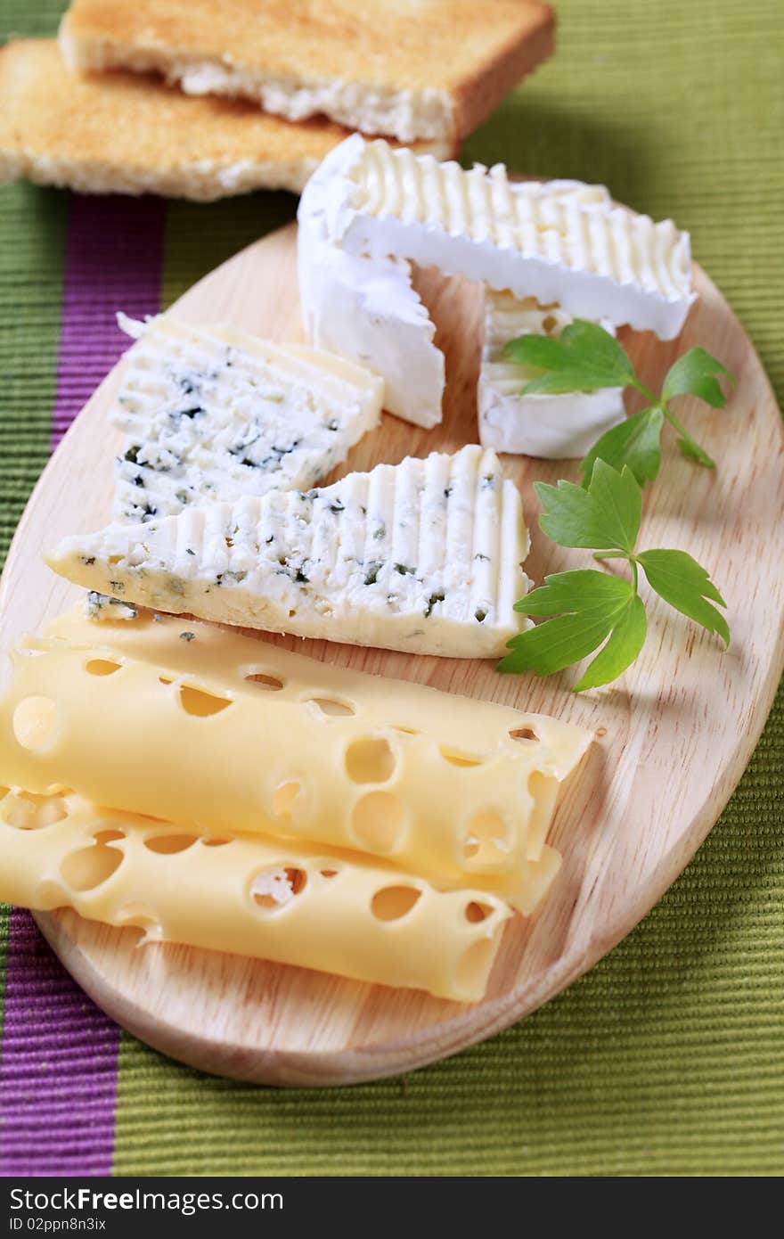 Variety of cheeses on a cutting board