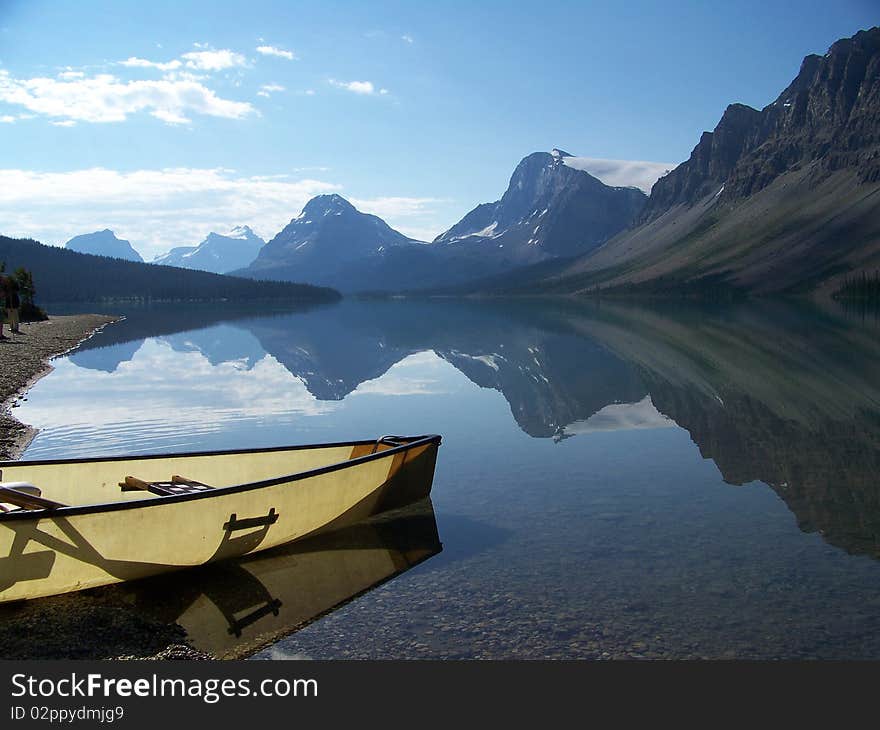 A Canoe floats on the shore of Bow Lake.