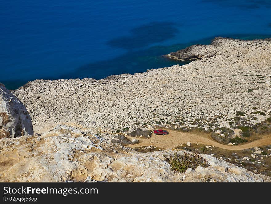 Shoreline of rocky desert at the foot of the mountain at the Cape El Greco, Cyprus. Shoreline of rocky desert at the foot of the mountain at the Cape El Greco, Cyprus