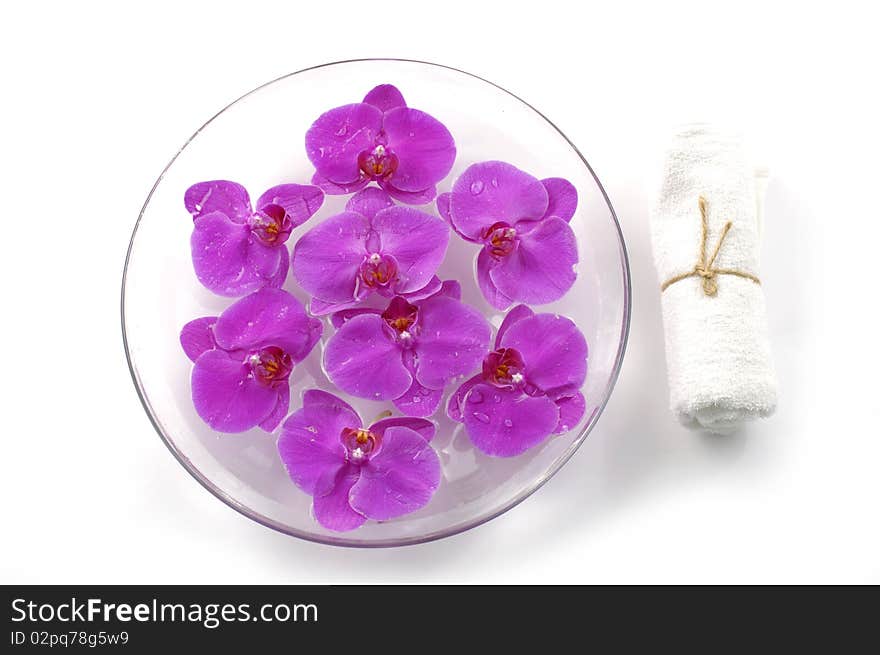 Bowl of orchid and white towel. Bowl of orchid and white towel