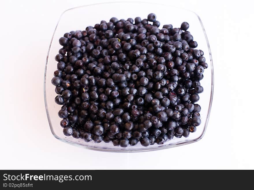 Blueberries in glass cup on isolated background