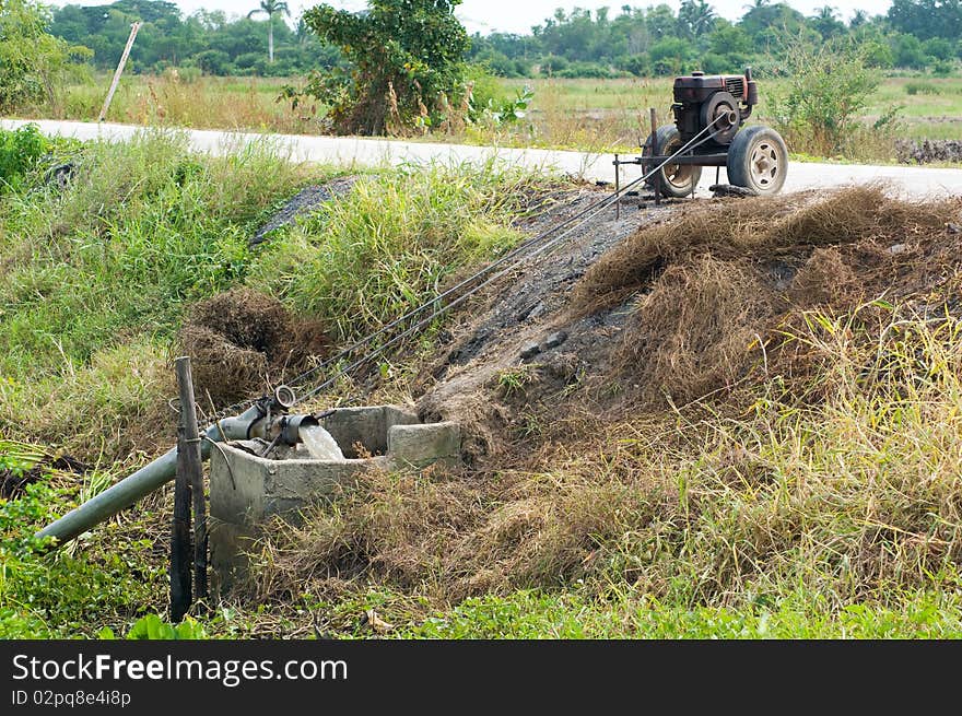 Simple irrigation pump among rice fields in Ang Thong province in Thailand. Simple irrigation pump among rice fields in Ang Thong province in Thailand.