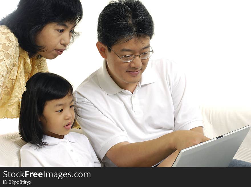 Parents and Daughter Using Laptop. Parents and Daughter Using Laptop