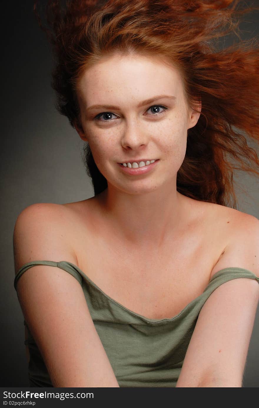 Redhead girl poses in the studio. Redhead girl poses in the studio