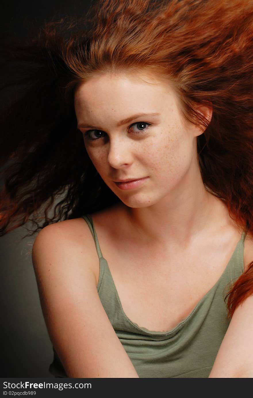 Redhead girl poses in the studio. Redhead girl poses in the studio