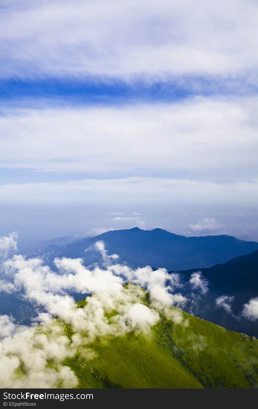 Mountain landscape with clouds and fog.