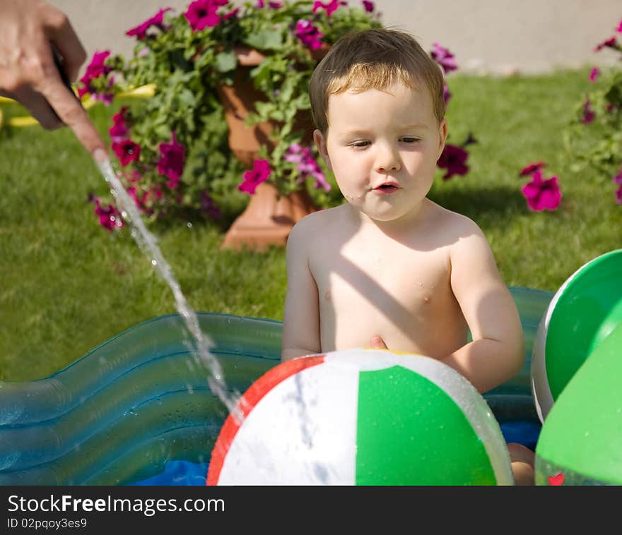 Toddler playing with water in the hot day