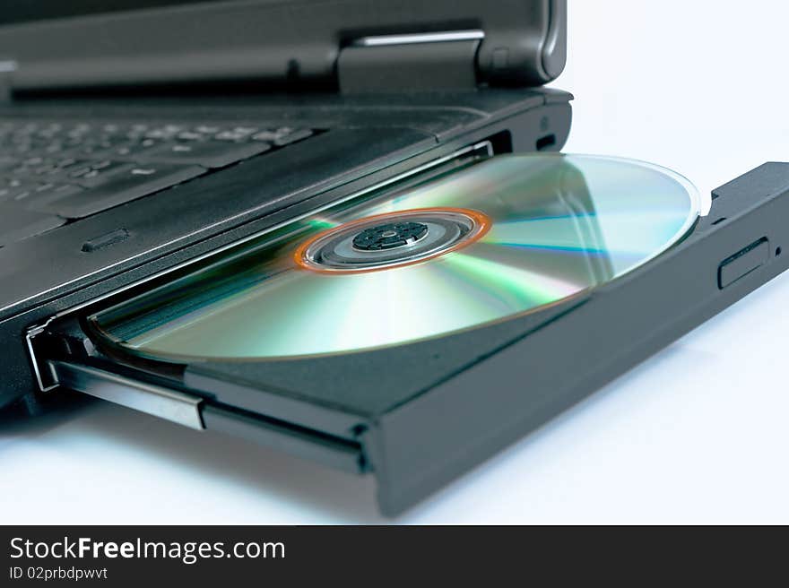 Laptop with a disk dvd. Blue tone. Laptop with a disk dvd. Blue tone