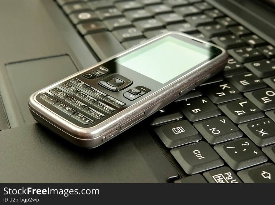 Mobile phone on a laptop.