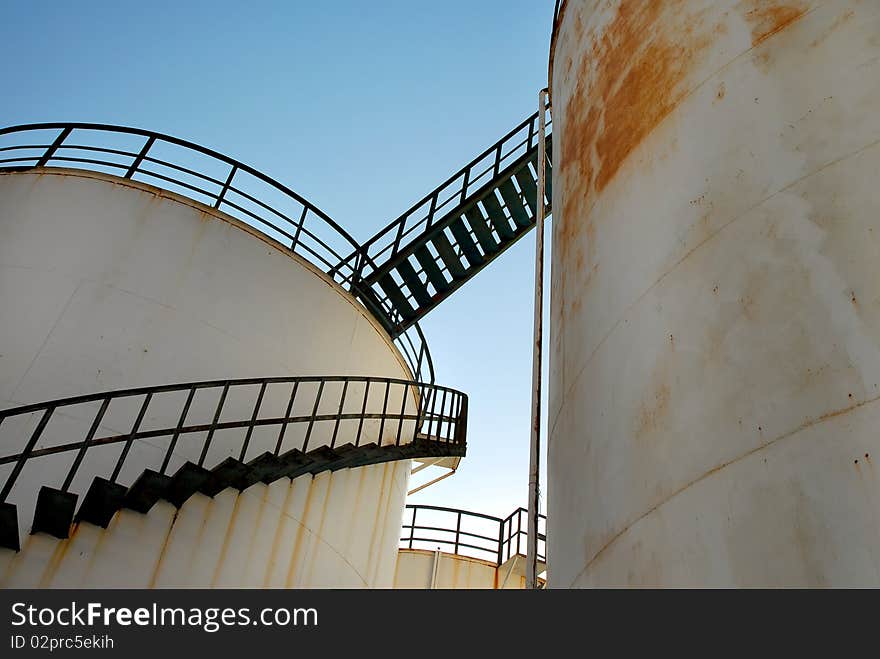 Abandoned Rusty Oil Silos With Blue Sky. Abandoned Rusty Oil Silos With Blue Sky