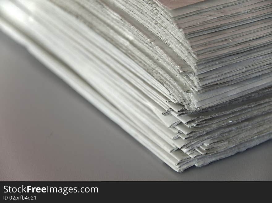 This image shows a stack of newspapers piled