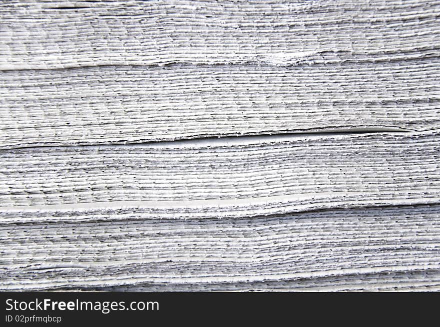 This image shows a stack of newspapers piled