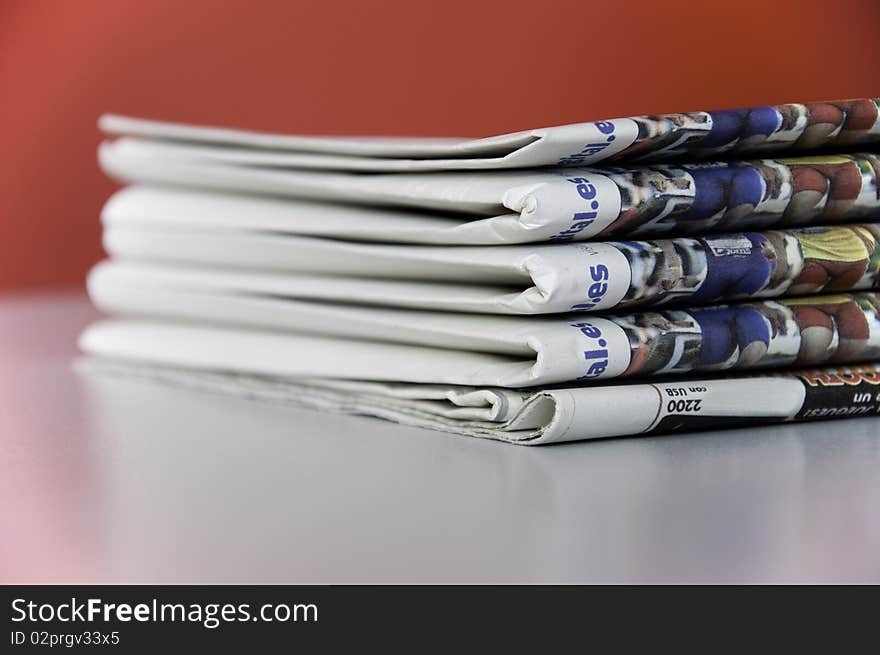 This image shows a stack of newspapers piled