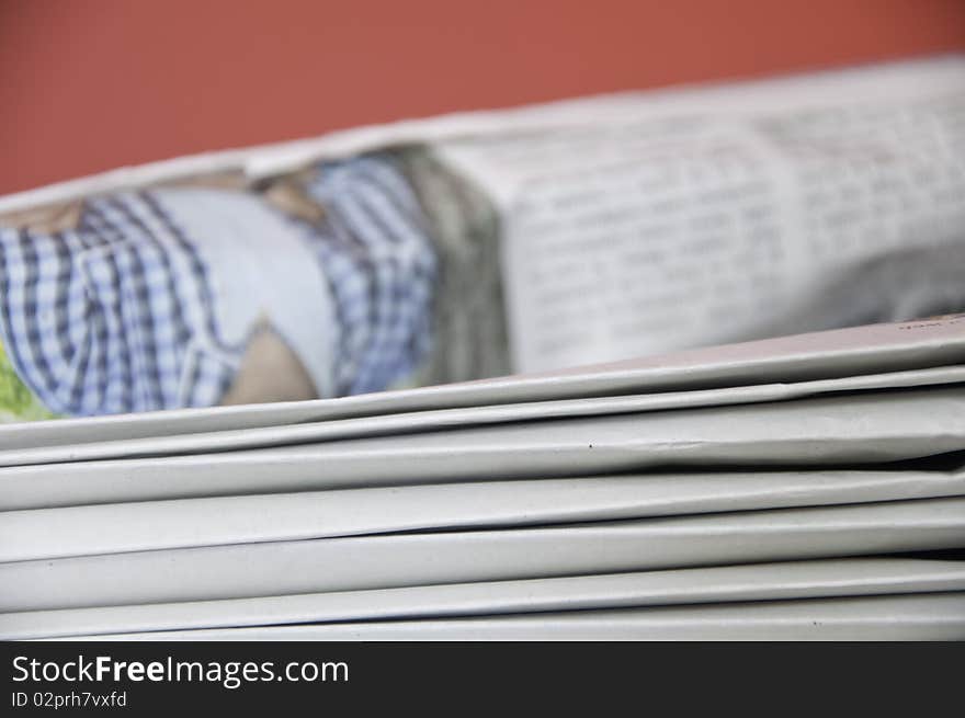 This image shows a stack of newspapers piled