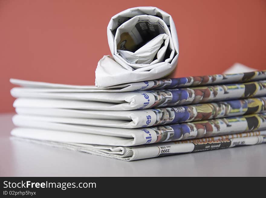 This image shows a stack of newspapers piled