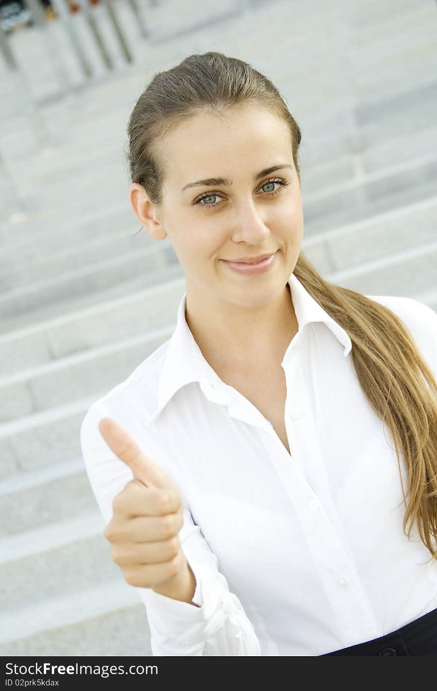 Young business woman shows a sign of OK. Young business woman shows a sign of OK.