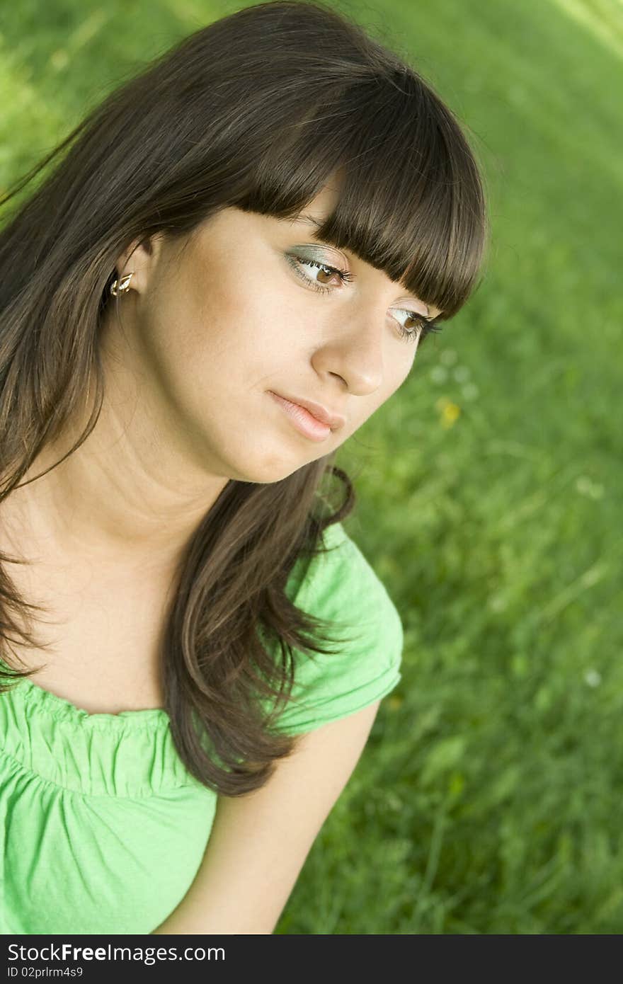 Young woman pensive outdoors in the park. Young woman pensive outdoors in the park