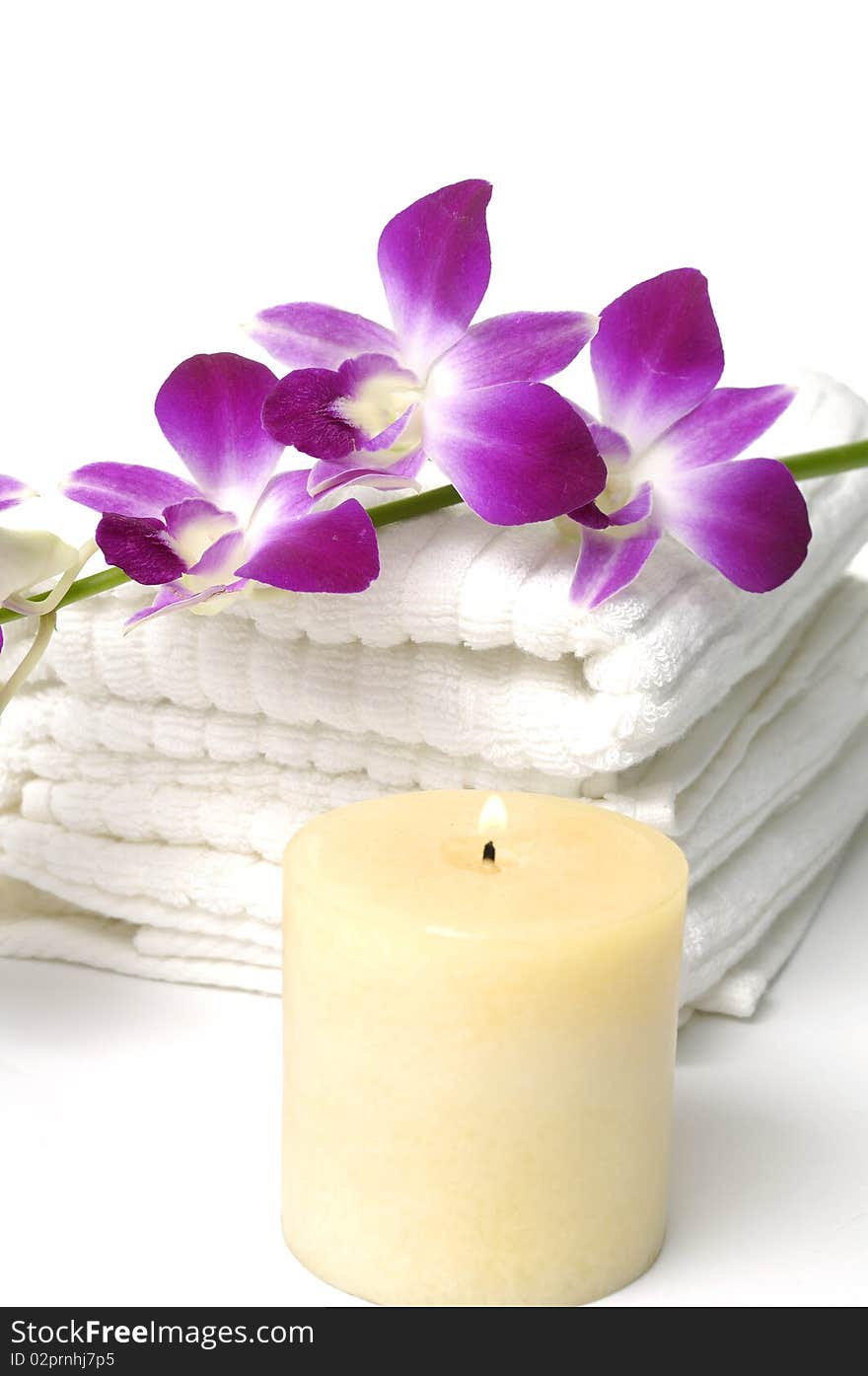 Tropical aromatherapy treatment-orchid on towel. Tropical aromatherapy treatment-orchid on towel