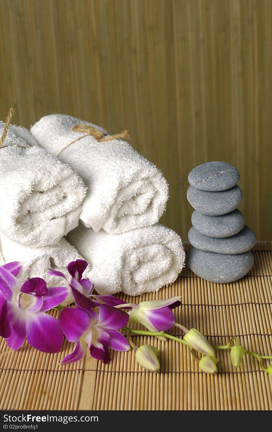 Spa and wellness: roll towels and a stack of zen pebbles