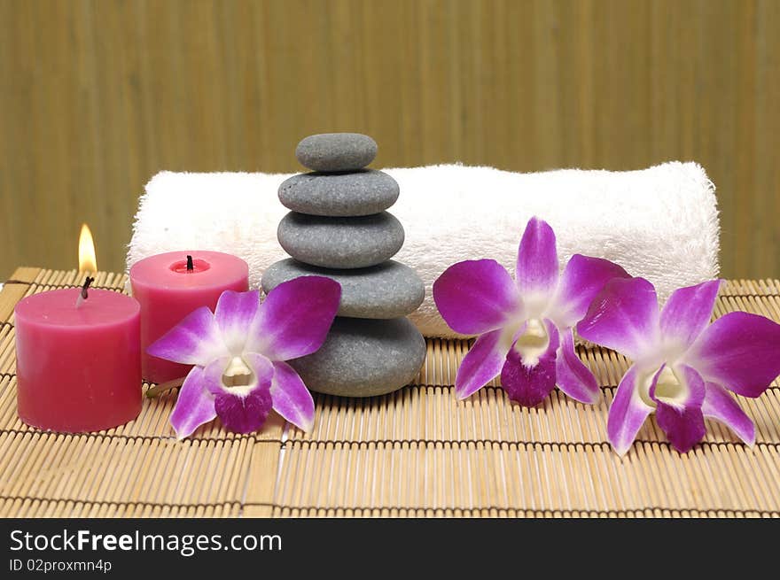 Spa with white candles on a brown backdrop