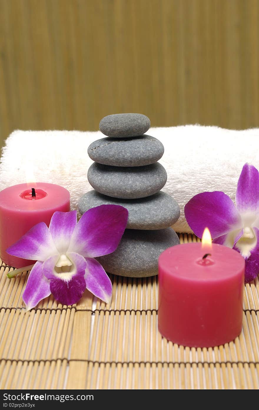 Spa with white candles on a brown backdrop