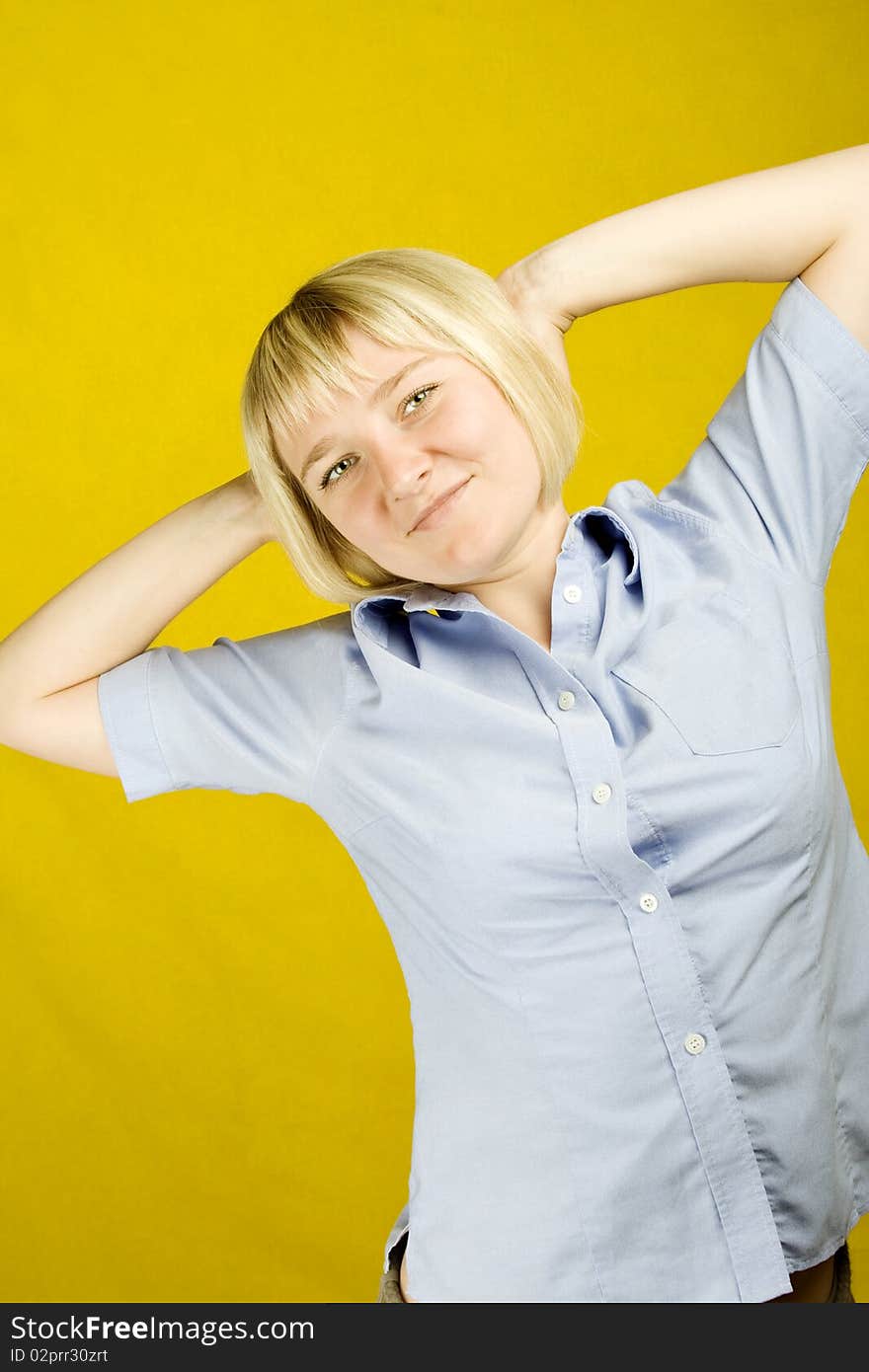 Young woman expressing emotions on a yellow background