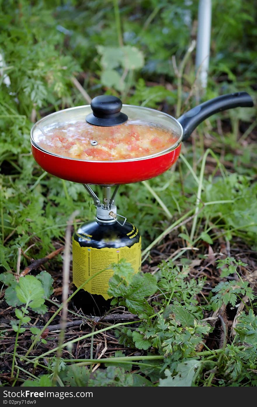 Tourist kitchen with a frying pan and gas bottle