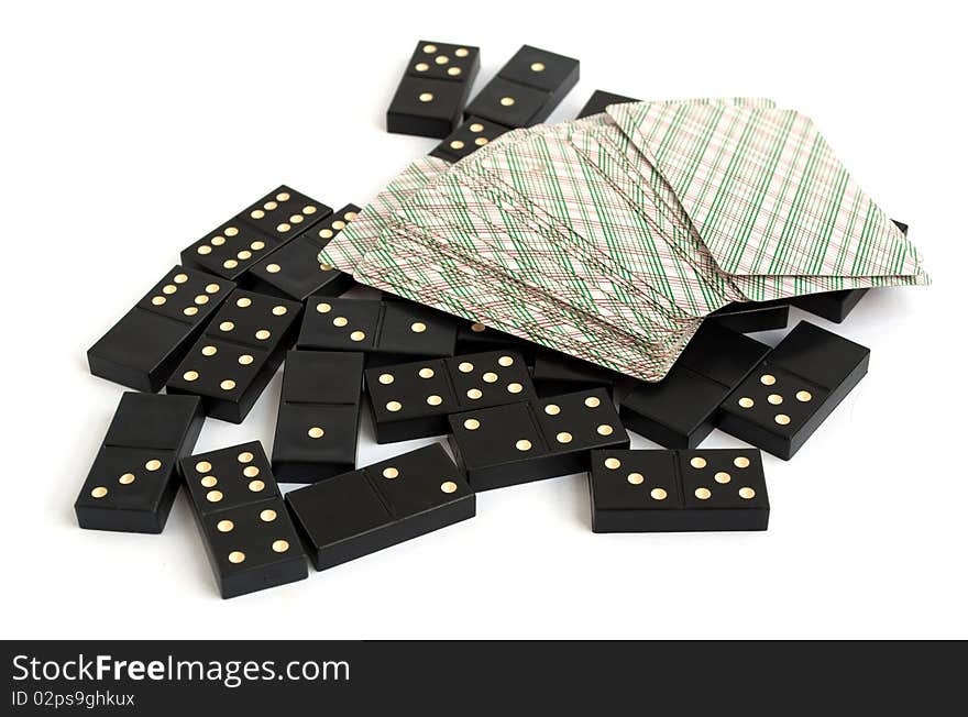 Dominoes and playing cards on white background