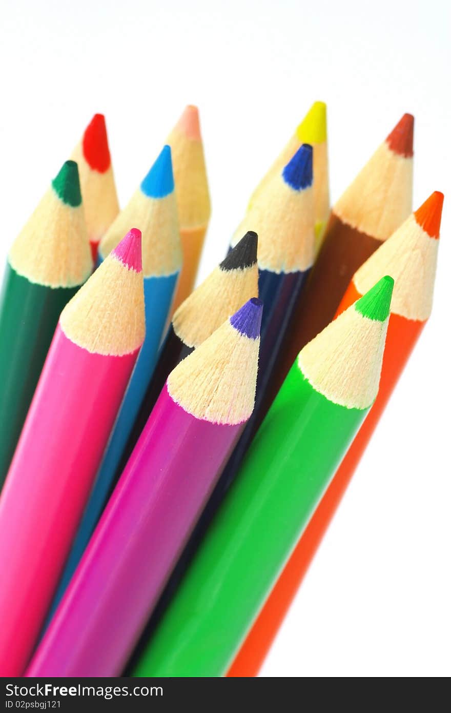 Close up of color pencils with different color over white background.