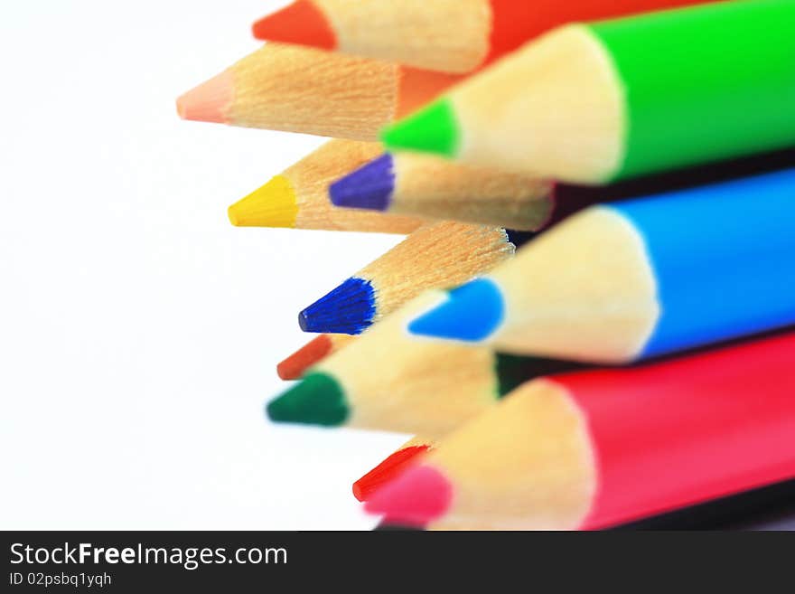 Close up of color pencils with different color over white background.