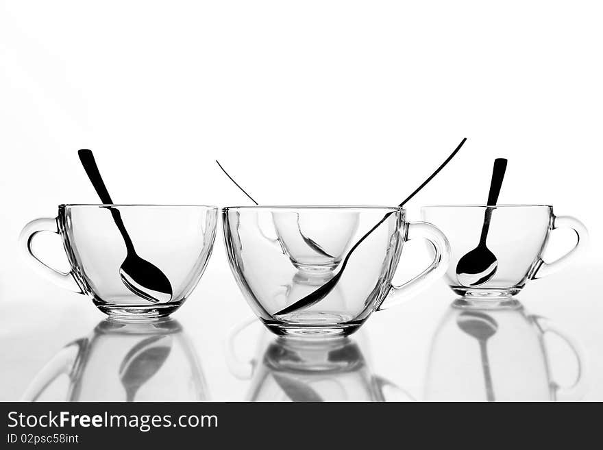 4 glass tea cups with reflection on white at 10Mps. 4 glass tea cups with reflection on white at 10Mps