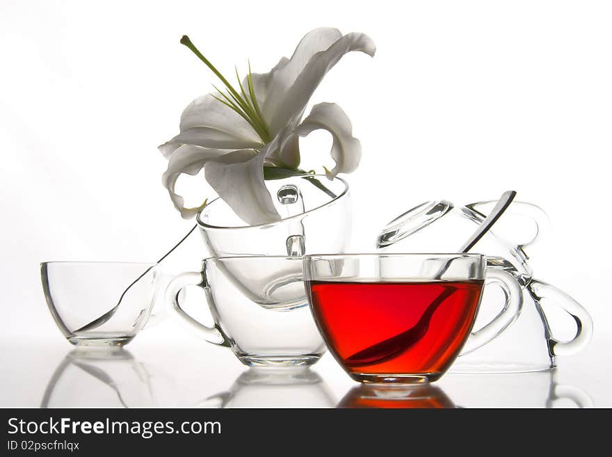 6 glass tea cups and flower with reflection on white at 10Mps. 6 glass tea cups and flower with reflection on white at 10Mps