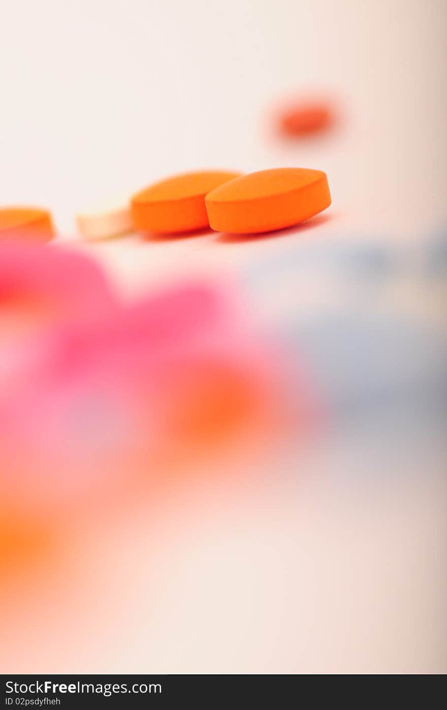 Orange pills on white background