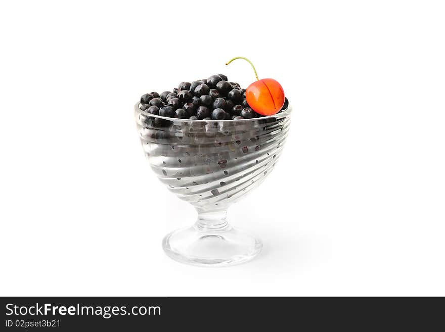 Blueberries and cherry in a glass bowl isolated on white. Blueberries and cherry in a glass bowl isolated on white