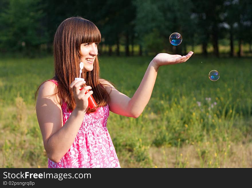 Girl blowing soap bubbles