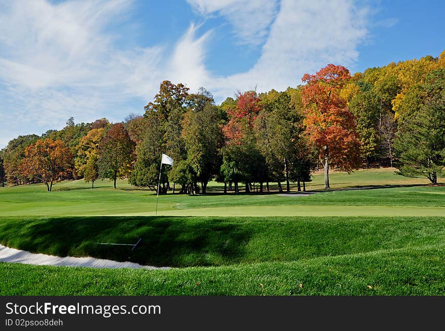 A golf green on a brilliant fall day. A golf green on a brilliant fall day