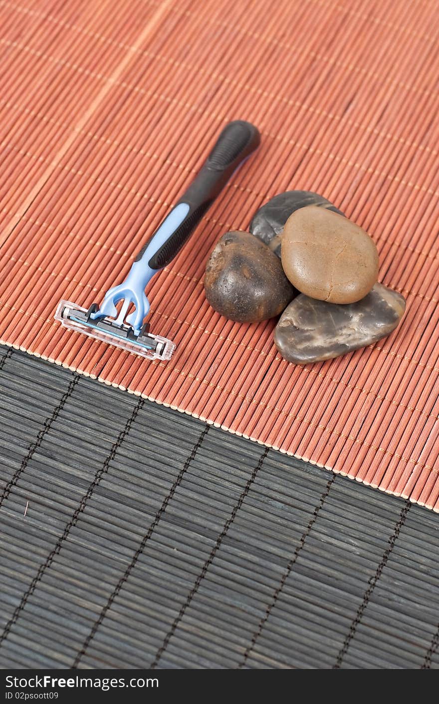 Razor with Decorative Stones on Bamboo Mat. Razor with Decorative Stones on Bamboo Mat