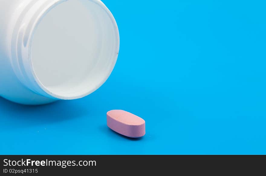 Pills from the medical can on blue background. Pills from the medical can on blue background.