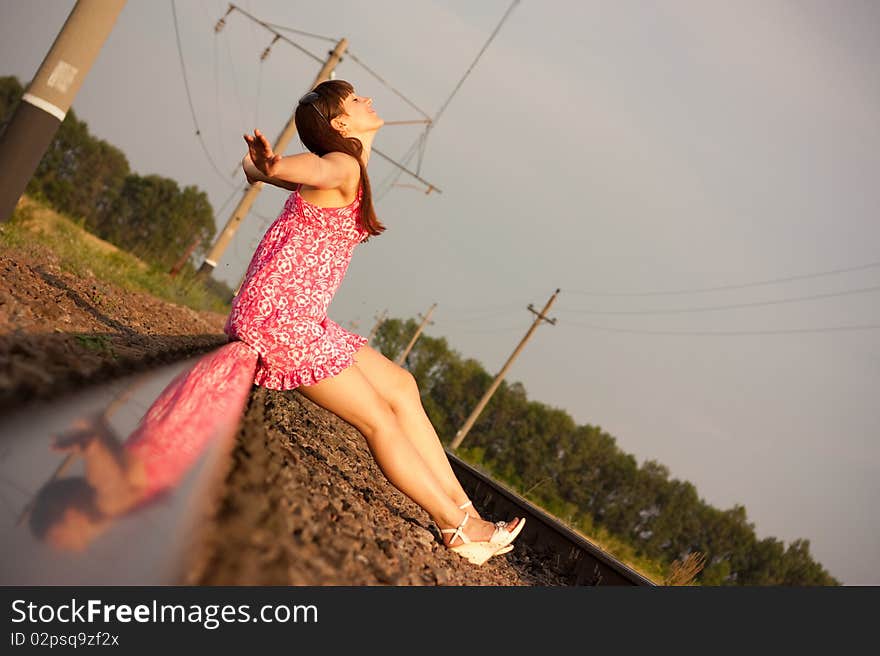 A beautiful girl sitting on rails. A beautiful girl sitting on rails