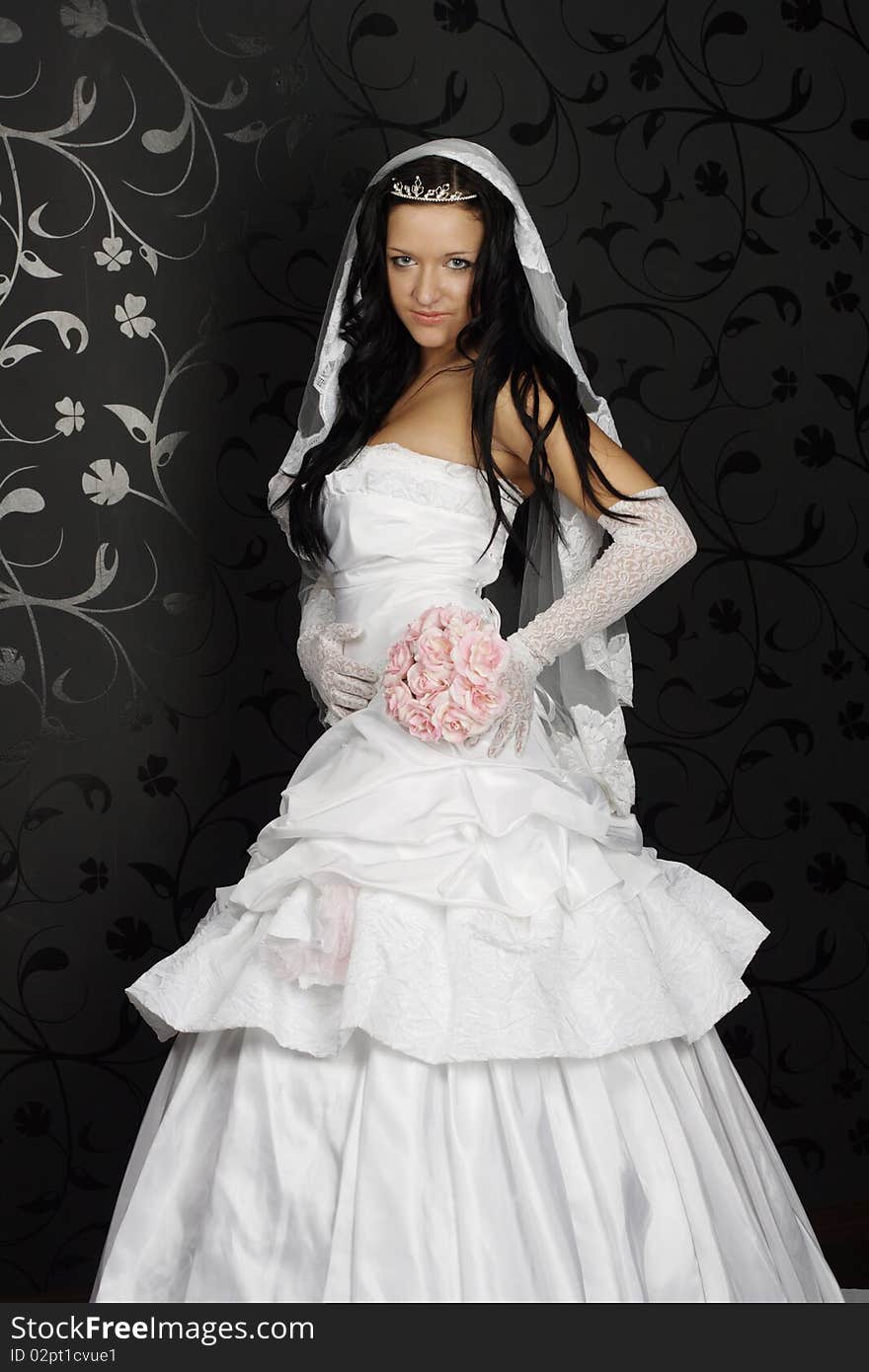 Portrait of beautiful happy bride in a wedding dress on black background studio shot. Portrait of beautiful happy bride in a wedding dress on black background studio shot