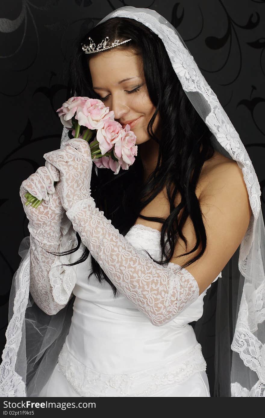 Portrait of beautiful happy bride in a wedding dress on black background studio shot. Portrait of beautiful happy bride in a wedding dress on black background studio shot