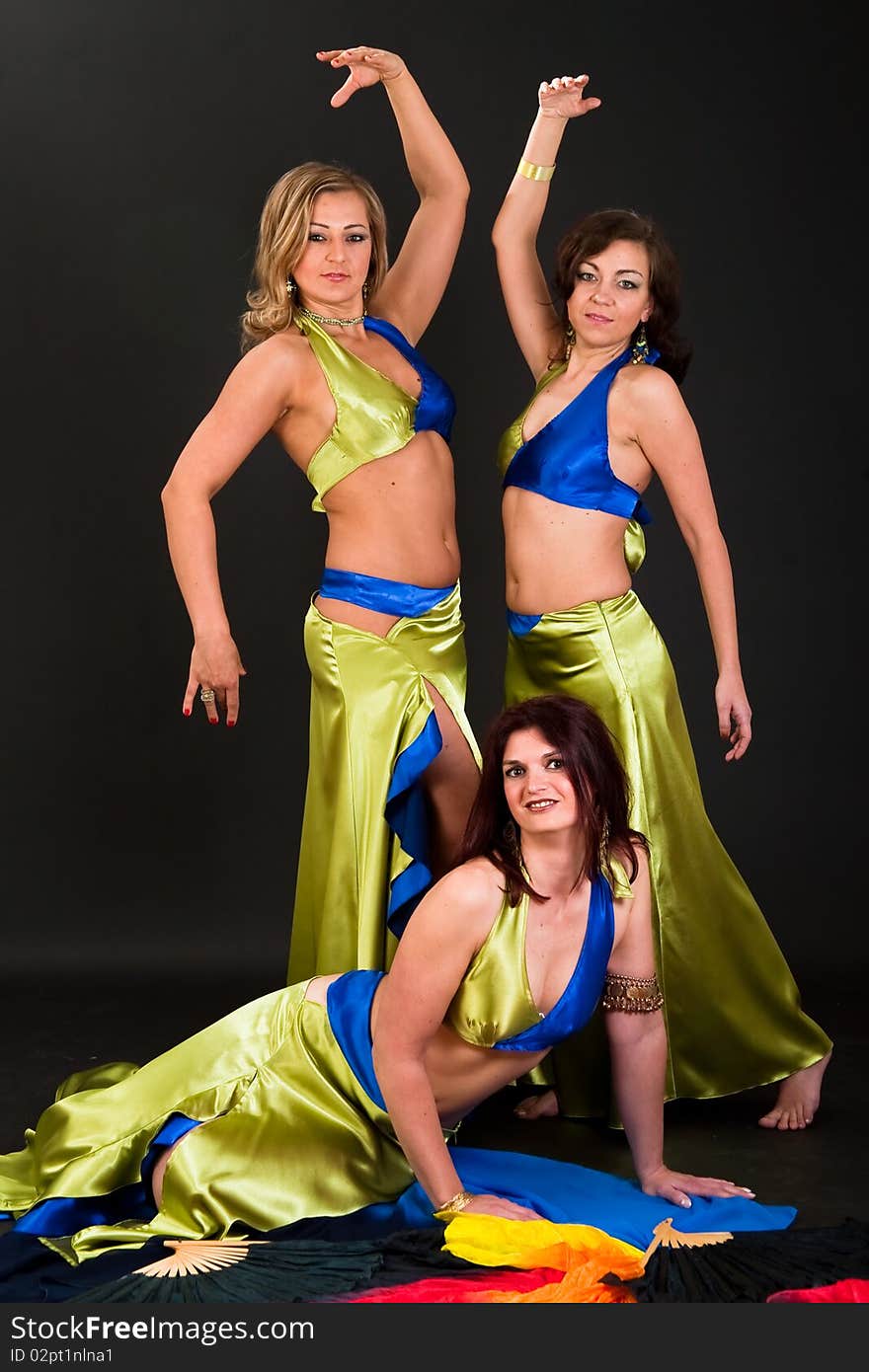 Group of three women perfoming exotic belly dance. Group of three women perfoming exotic belly dance