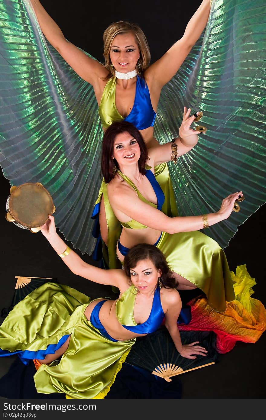 Group of three  women perfoming exotic belly dance. Group of three  women perfoming exotic belly dance