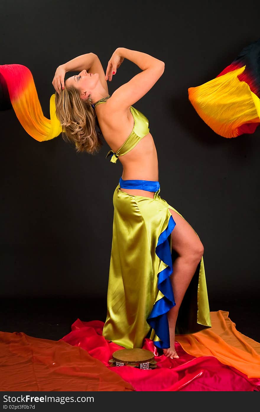 Beautiful belly dancer woman in front of black background