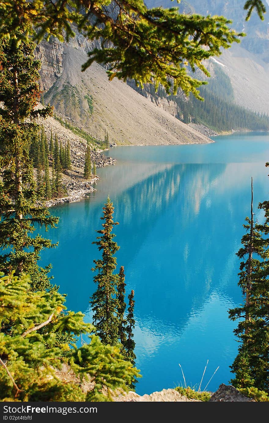 This is Beautiful Moraine Lake in The Canadian Rockies.  This glacier lake gets its crystal blue water look from silt on the bottom.