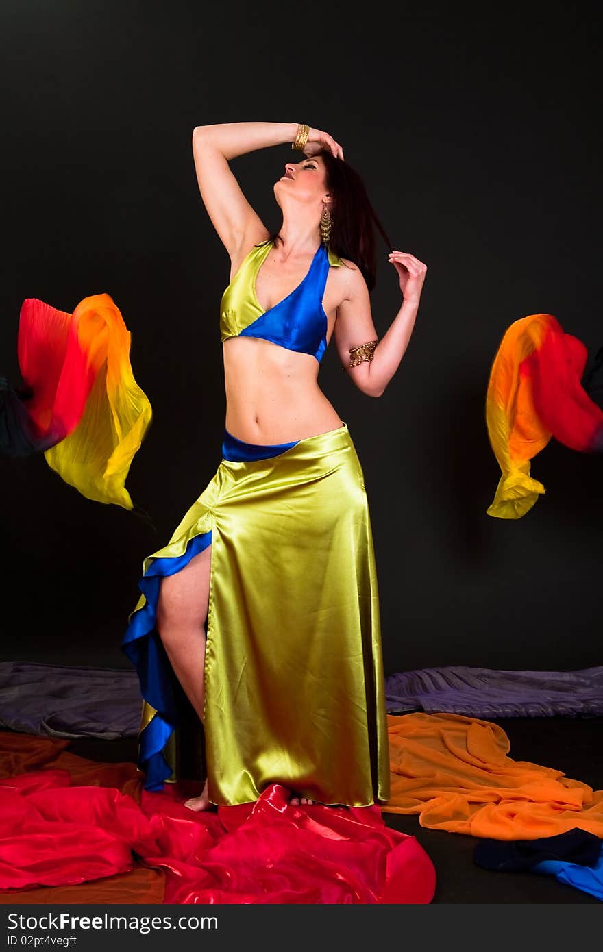 Beautiful belly dancer woman in front of black background