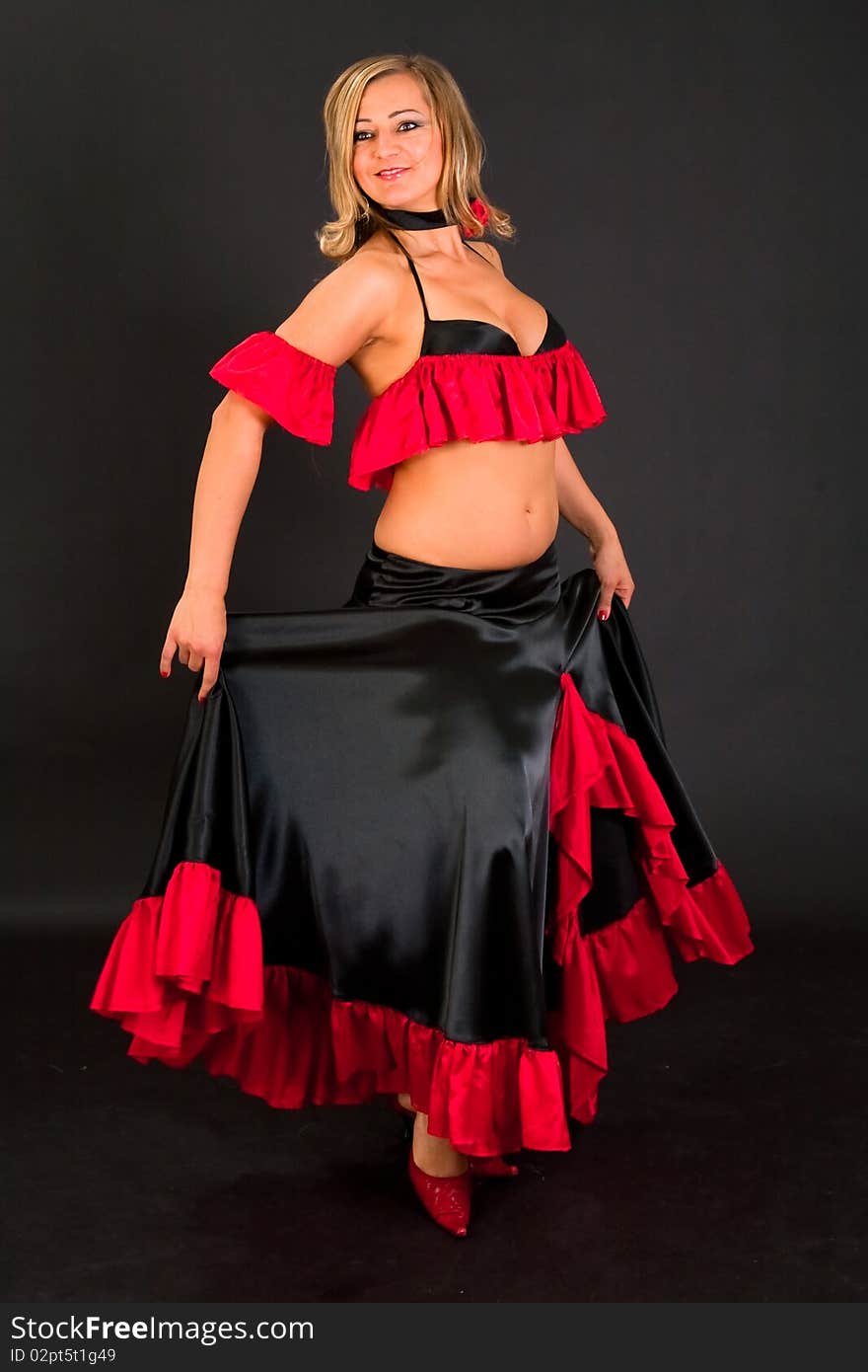 Beautiful belly dancer woman in front of black background