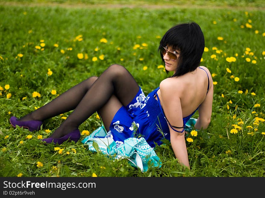 Summer girl against a background of green grass. Summer girl against a background of green grass